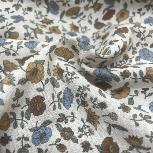 Cotone con stampa di fiori ocra e turchesi.