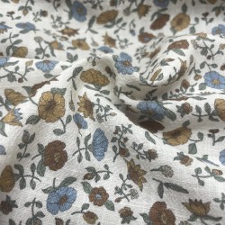 Cotone con stampa di fiori ocra e turchesi.